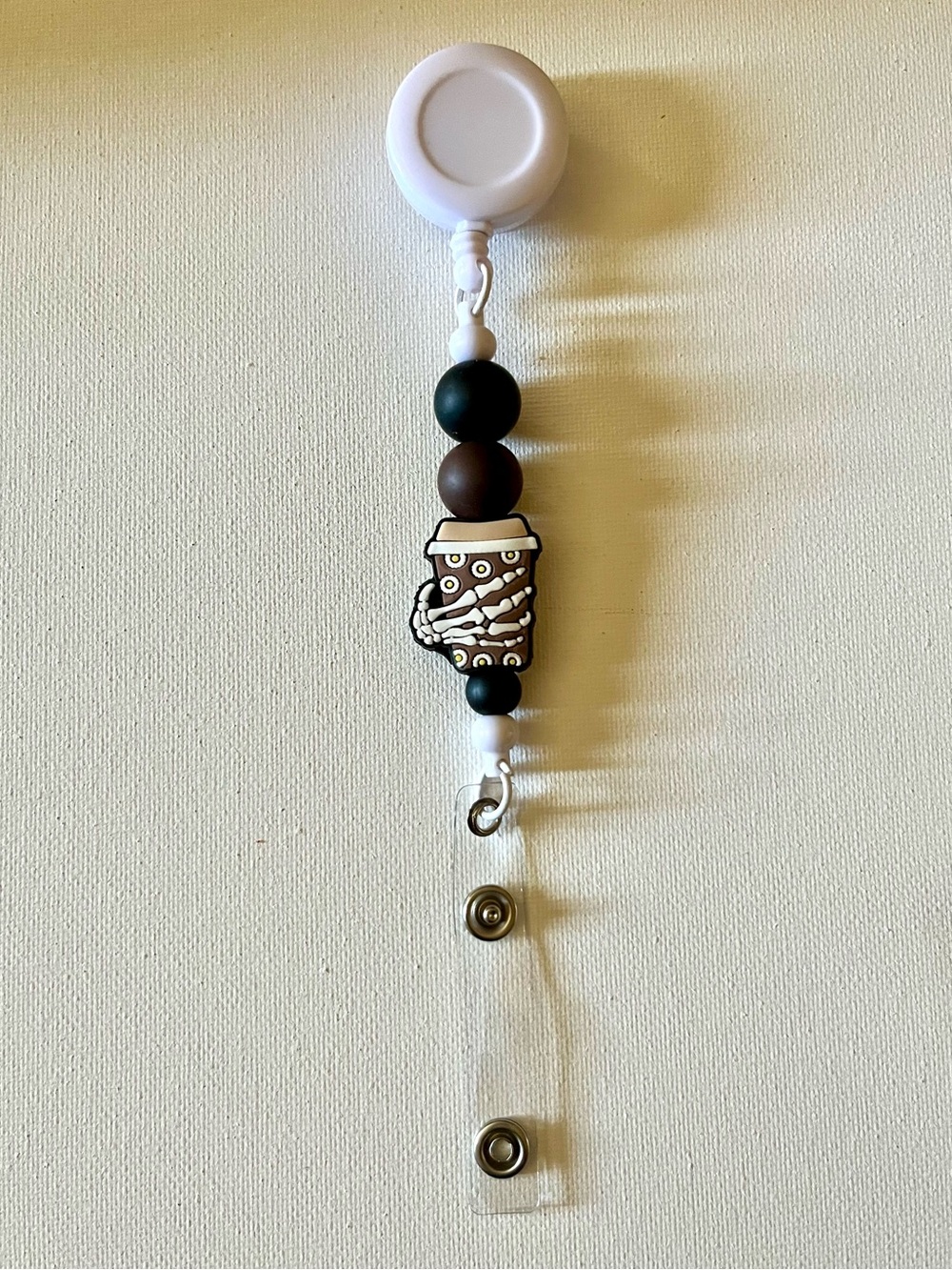 Beaded Skeleton Hand Holding a Coffee Cup Badge Reel